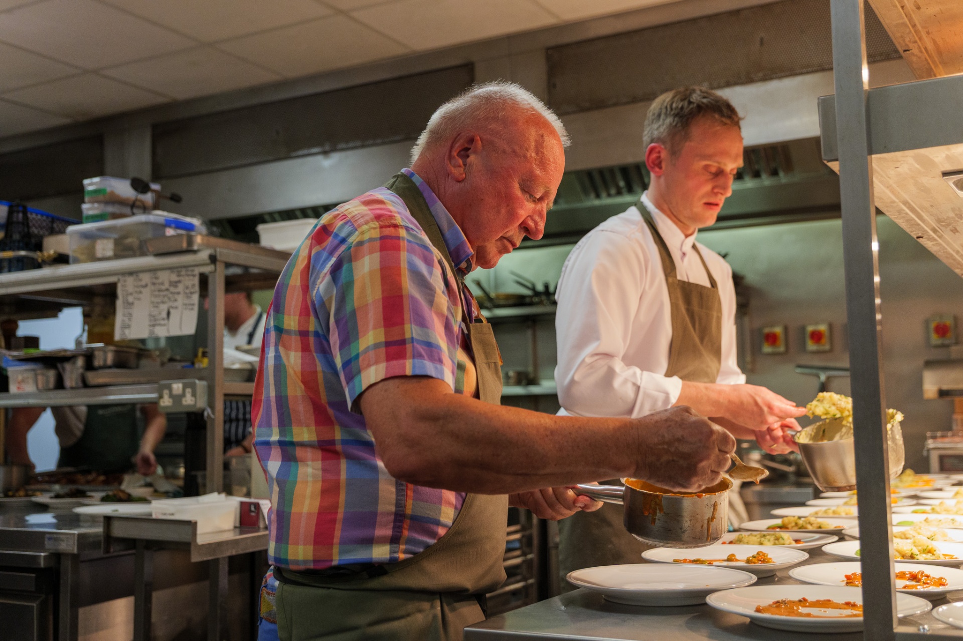 Chefs plating lunch in the kitchen